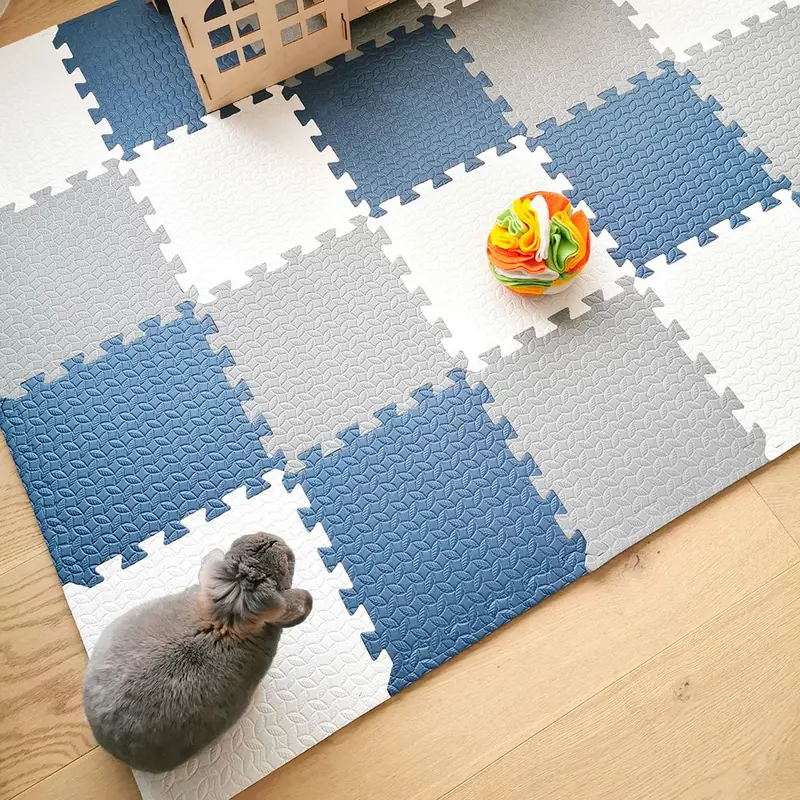 Blue, white and gray Rabbit World foam puzzle floor tiles arranged in an indoor rabbit play area.
